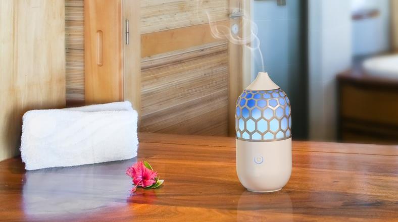 Image of an essential oil diffuser on table near bedroom