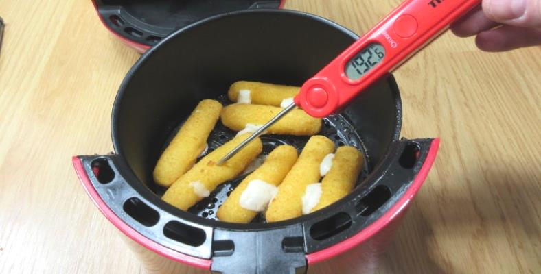 Example of checking the internal temperature of cheese sticks while cooking with a digital thermometer